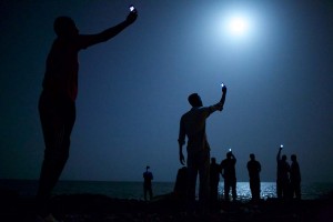 World Press Photo of the Year 2013 John Stanmeyer, USA, VII for National Geographic 26 February 2013, Djibouti City, Djibouti African migrants on the shore of Djibouti city at night, raising their phones in an attempt to capture an inexpensive signal from neighboring Somalia—a tenuous link to relatives abroad. Djibouti is a common stop-off point for migrants in transit from such countries as Somalia, Ethiopia and Eritrea, seeking a better life in Europe and the Middle East.