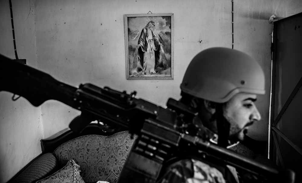 Baqufa, Iraq - 18.11.2014: The christian-assyrian Dwekh Nawsha militia can be seen at their base in Baqufa at the frontline in the Ninive-plain. The militia is the armed wing of the ANP (Assyrian Patriotic Party), and acts to protect christian places and villages in the Ninive-plain north of Mosul, where they fight alongside the Peshmerga-troops against the IS. In November 2014, the group consisted of 40 Fighters, lightly armed, and 200 christian volunteers waiting to join the militia. Here, fighters of the Dwekh Nawsha can be seen inside the church compound of Baqufa.