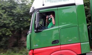 Das Handy am Steuer - auch beidhändig filmt dieser LKW-Fahrer - bei voller Fahrt auf der Autobahn.