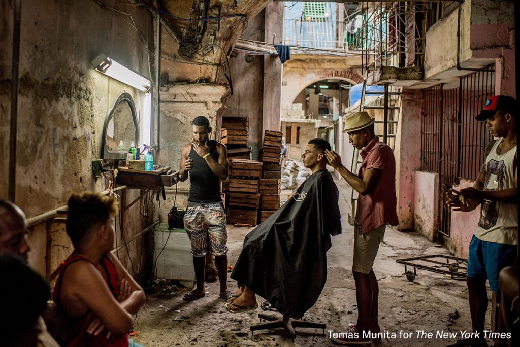 A weathered barber shop in Old Havana, Cuba. Story: In December, days after Fidel Castro’s death, his ashes were taken into the countryside, on a route that retraced, in reverse, the steps of the revolution he led in 1959. Towns and villages along the route were emptied of residents as thousands tried to catch a glimpse of Castro’s remains. For many, the death of Fidel Castro felt like that of a father. In death, as in life, Fidel Castro demanded reverence. Cuba brims with life, a contrast drawn sharper amid its faded grandeur. From one end of the country to the other, thousands of Cubans waited to bid farewell to Fidel.