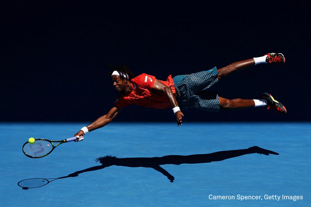 Gaël Monfils of France dives for a forehand in his fourth round match against Andrey Kuznetsov of Russia, during the 2016 Australian Open at Melbourne Park, Australia, on 25 January 2016. The Australian Open holds the record for the highest attendance at a Grand Slam event.