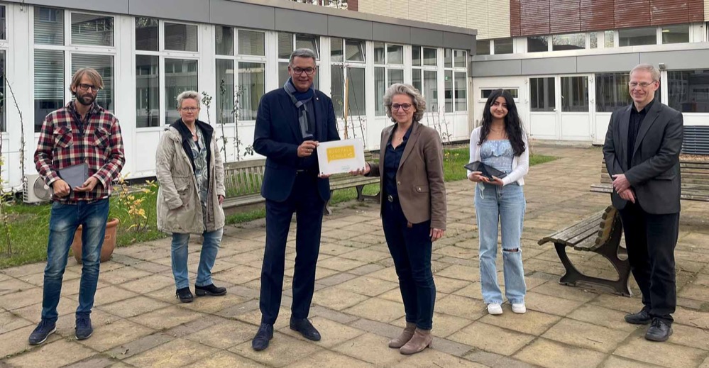 die letzten Jahre – insbesondere auch die eineinhalb Jahre unter Corona – standen am Stadtgymnasium unter dem Leitstern der Digitalisierung. Viele kleine und große Schritte auf diesem Weg haben unsere Schule zu einem neuen Meilenstein geführt: Als erst zweite Schule Dortmunds hat das Stadtgymnasium das Siegel „Digitale Schule“ erhalten, als einzige Schule sogar mit der höchsten Auszeichnung „professional“. Im Rahmen einer offiziellen Verleihungszeremonie begrüßt das Stadtgymnasium dazu unter anderen den Oberbürgermeister Herrn Westphal sowie die Schuldezernentin Frau Schneckenburger in der Aula am Ostwall. Herr Schwarz (Digitalisierungsteam Stadtgymnasium), Frau Amadi (Elternvertreterin), Herr Westphal (Oberbürgermeister), Frau Klimasch (Schulleiterin), Frau Mohammad (Schülersprecherin), Herr Depenbrock (Schulverwaltungsamt).