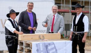 Richtfest in Brechten: OB Thomas Westphal (2. v.l.) und VIVAWEST-Chef Uwe Eichner, (2. v.r.), eingerahmt von zwei Zimmerleuten.