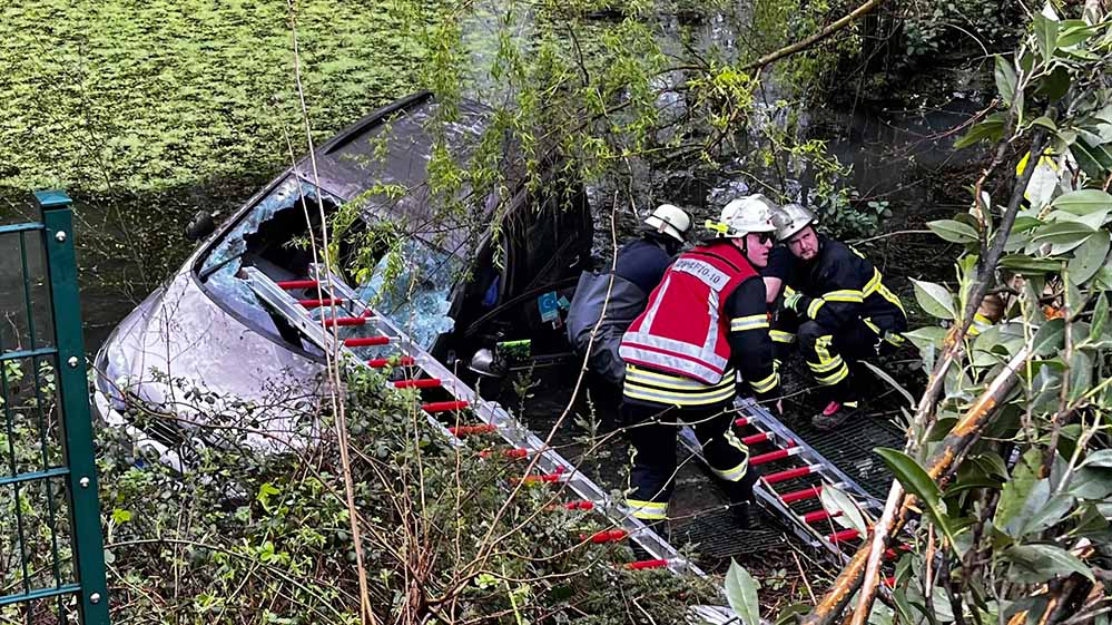 Rettung der PKW-Insassen - der 89-jährige Fahrer hatte rückwärts fahrend einen Zaun durchbrochen und waren einen Abhang hinunter gefahren und landete in einem Teich.