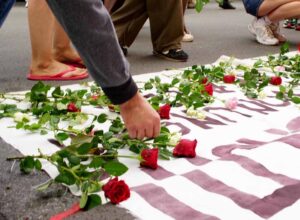 Menschen liegen Blumen nieder