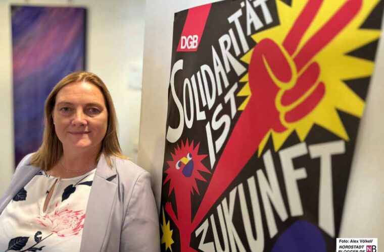 Sie steht vor einem Plakat mit der Botschaft: Solidarität ist Zukunft