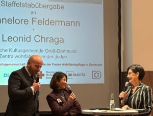 Zwei Personen im Gespräch mit der Moderatorin